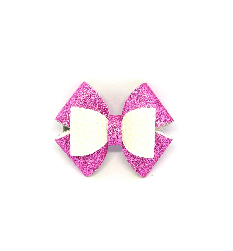 Pink glitter hair bow with white center on a white background
