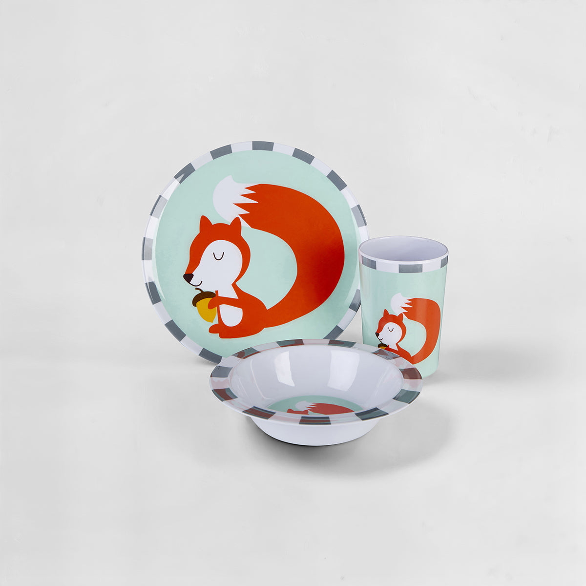 Children's dinnerware set with squirrel design on a light gray background