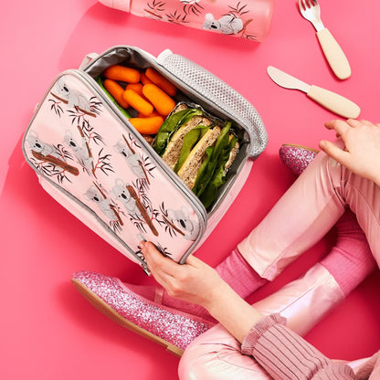 Lunchbox with food on a pink background, featuring a person in pink shoes.