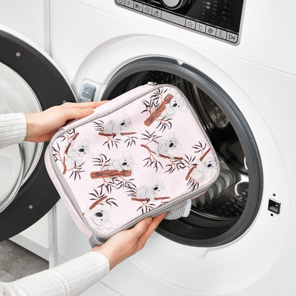 Person holding a patterned pouch in front of an open washing machine