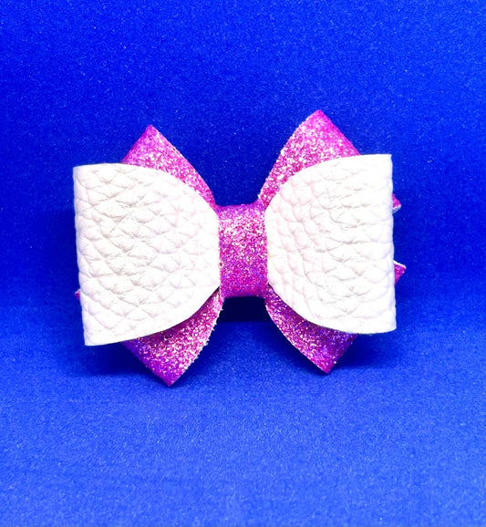 White and pink glitter bow on a blue background