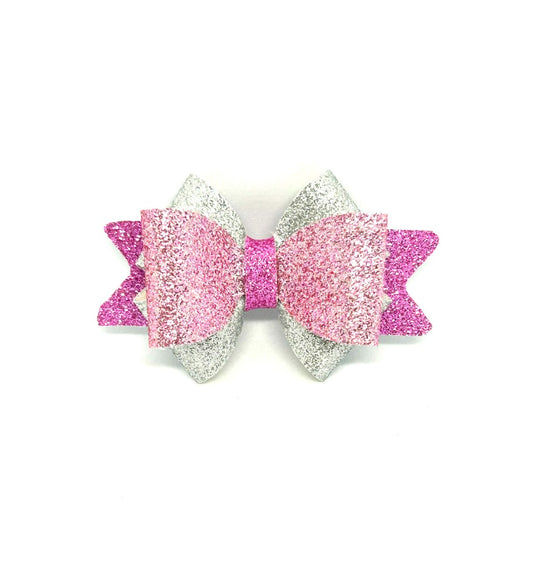 Pink and silver glittery hair bow on a white background