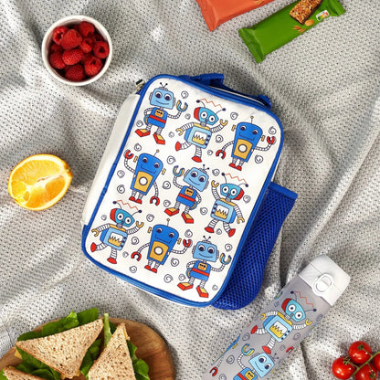 Lunch bag with robot pattern surrounded by snacks on a textured surface