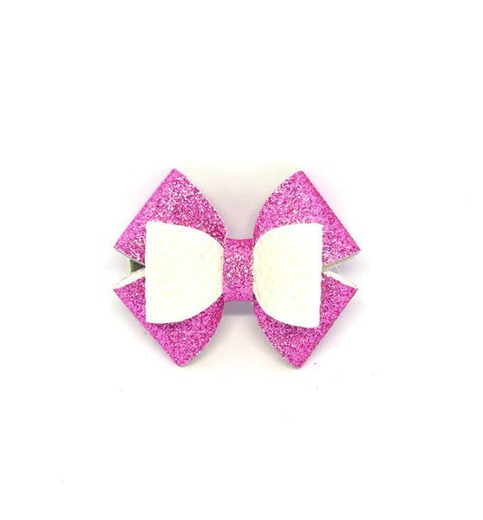 Pink glitter hair bow with white center on a white background