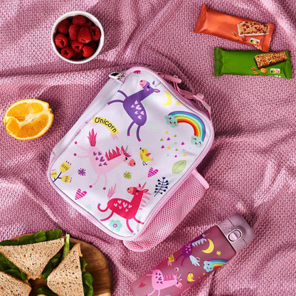 Pink lunch bag with unicorn design on a pink blanket with snacks and a water bottle.