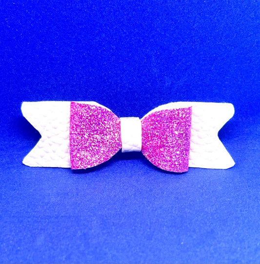 White and pink glitter bow on a blue background