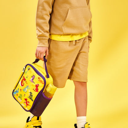 Person wearing a beige outfit with a colorful bag on a yellow background